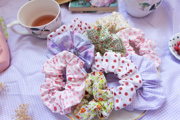 an assortment of colourful scrunchies on a plate in a picnic setting.