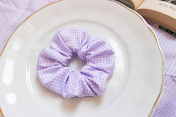 a purple and white gingham print scrunchie.